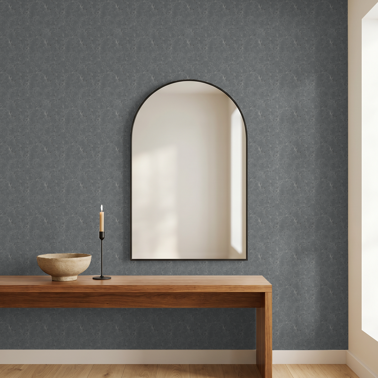 Navy floral vine wallpaper in modern room with wooden table and arched mirror.