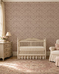Antique damask rosewood wallpaper in elegant nursery with crib and dresser.