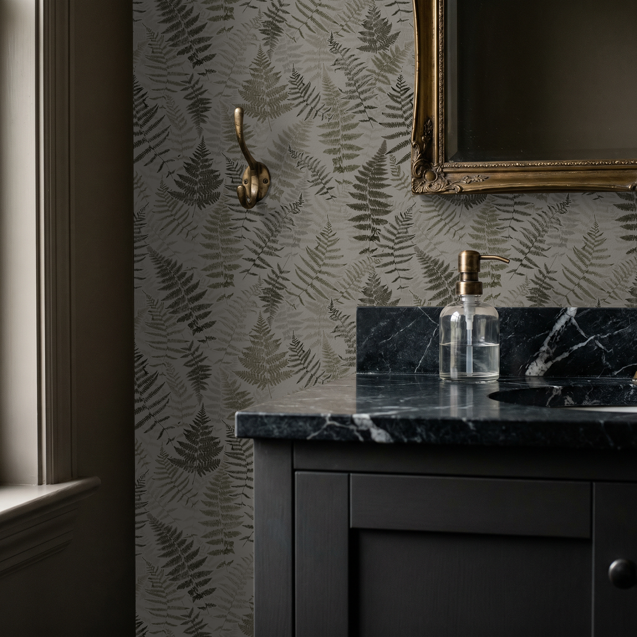 Botanical fern wallpaper in bathroom with gold mirror and black marble sink