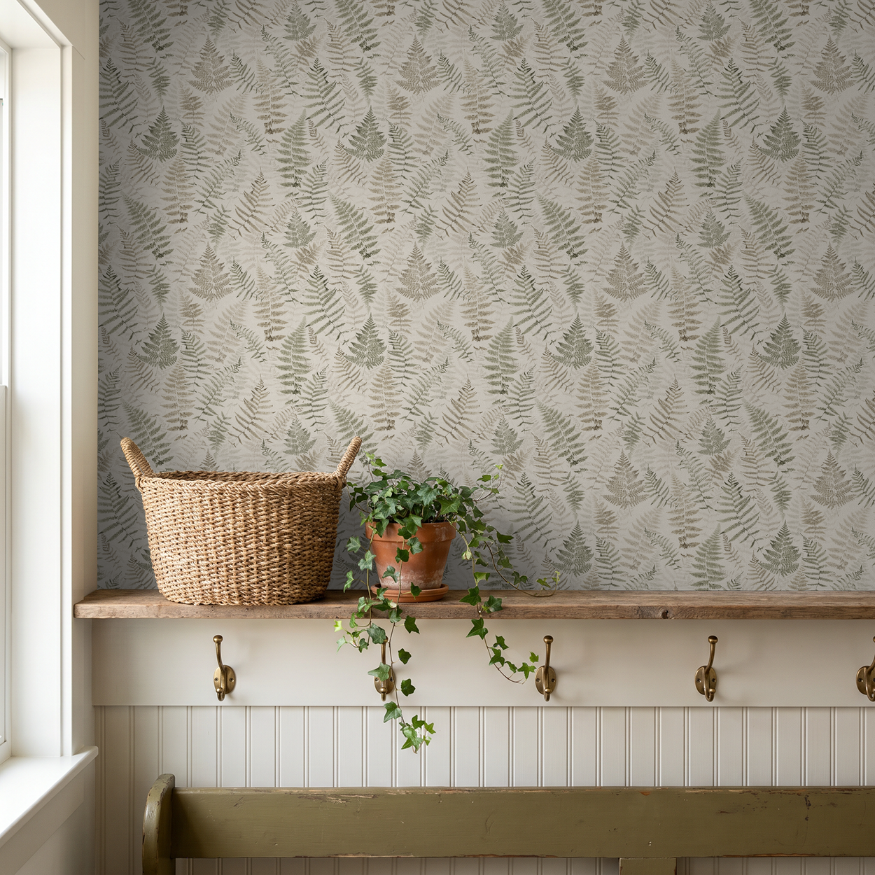 Botanical fern wallpaper in soft cream and walnut with wicker basket and plant.