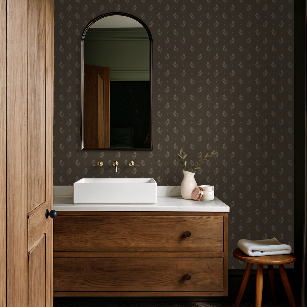 Botanical floral wallpaper in earthy tones in a rustic bathroom setting.