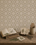 Botanical lattice taupe wallpaper with leafy motifs in a rustic setting.