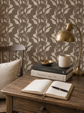Botanical vine cream on taupe wallpaper in cozy study with wooden desk and brass lamp.