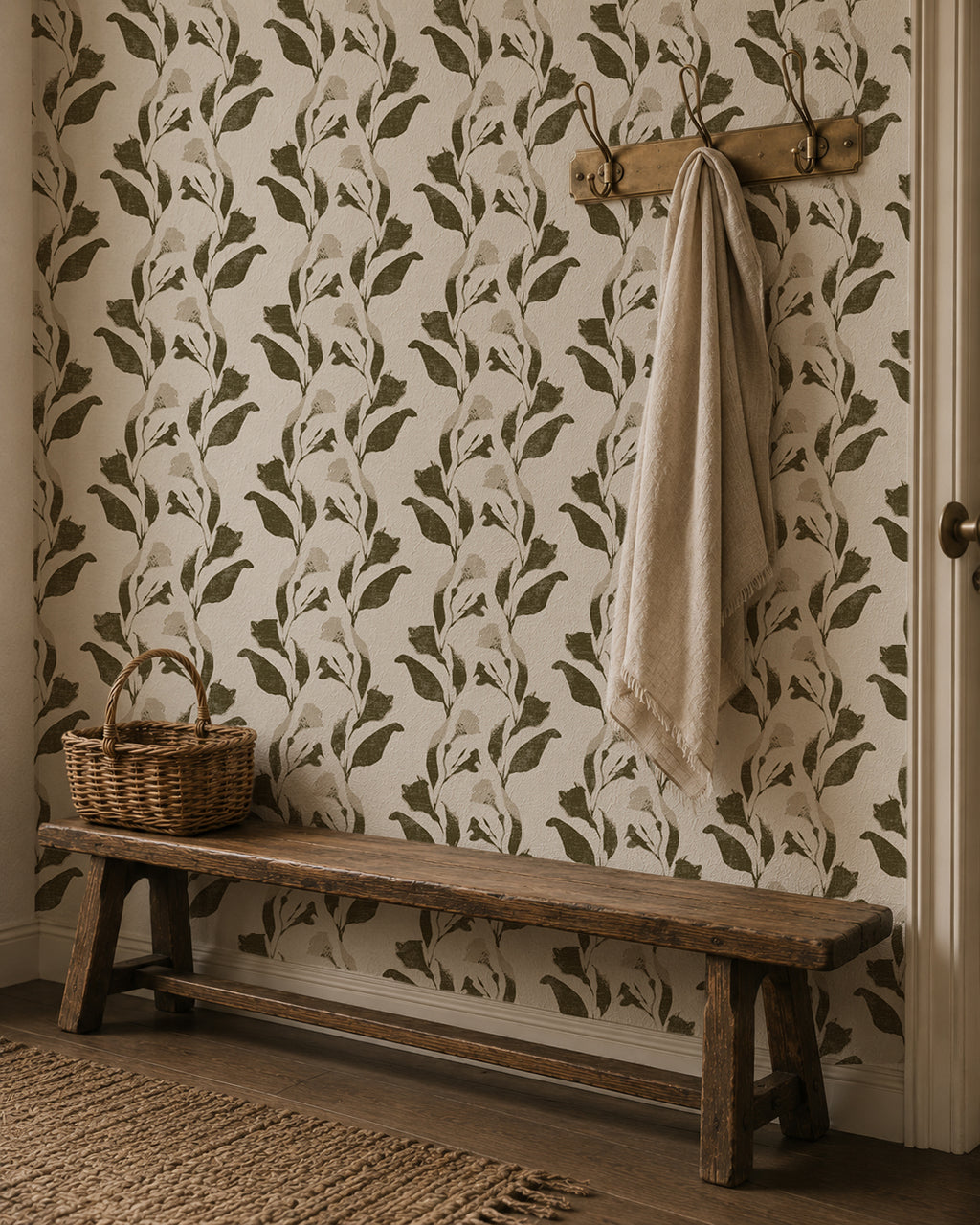 Botanical vine wallpaper with olive and cream leaf pattern in rustic hallway setting.