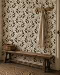Botanical vine wallpaper with olive and cream leaf pattern in rustic hallway setting.