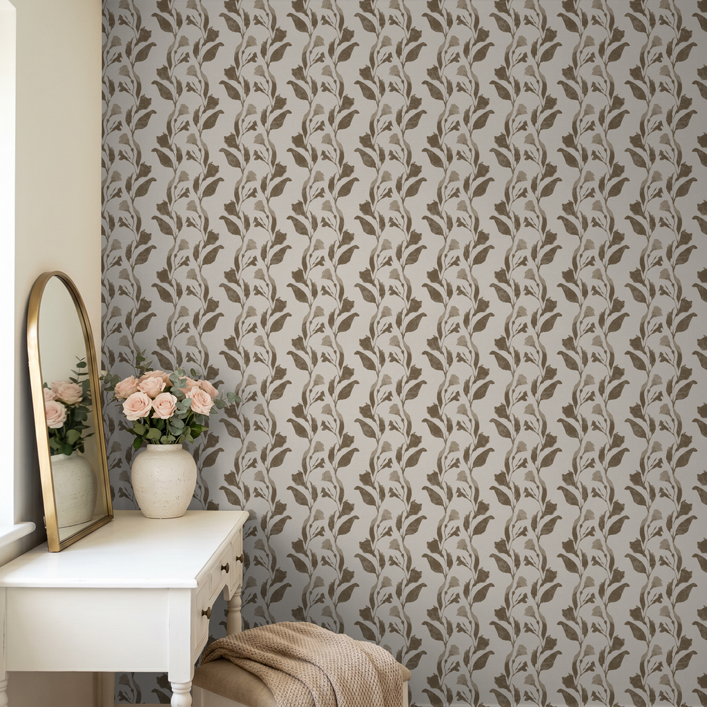 Botanical vine taupe on cream wallpaper in elegant room with vanity and flowers.