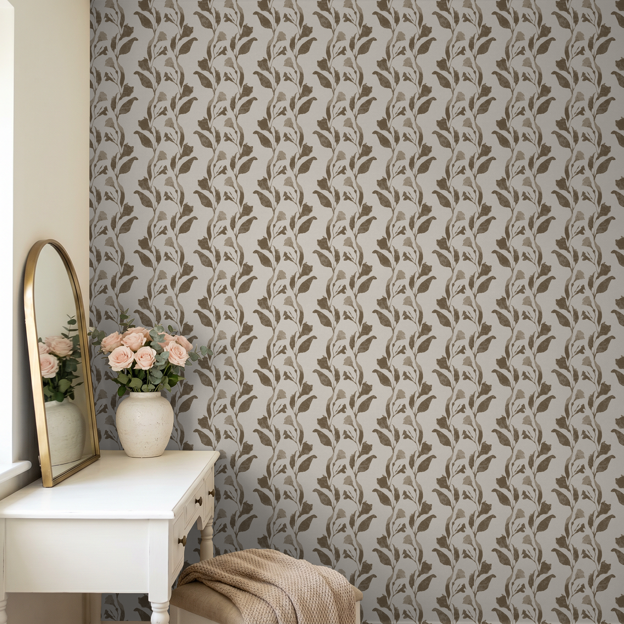 Botanical vine taupe on cream wallpaper in elegant room with vanity and flowers.