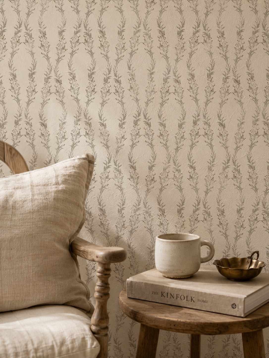 Botanical wallpaper with gray motifs in cozy rustic room setting.