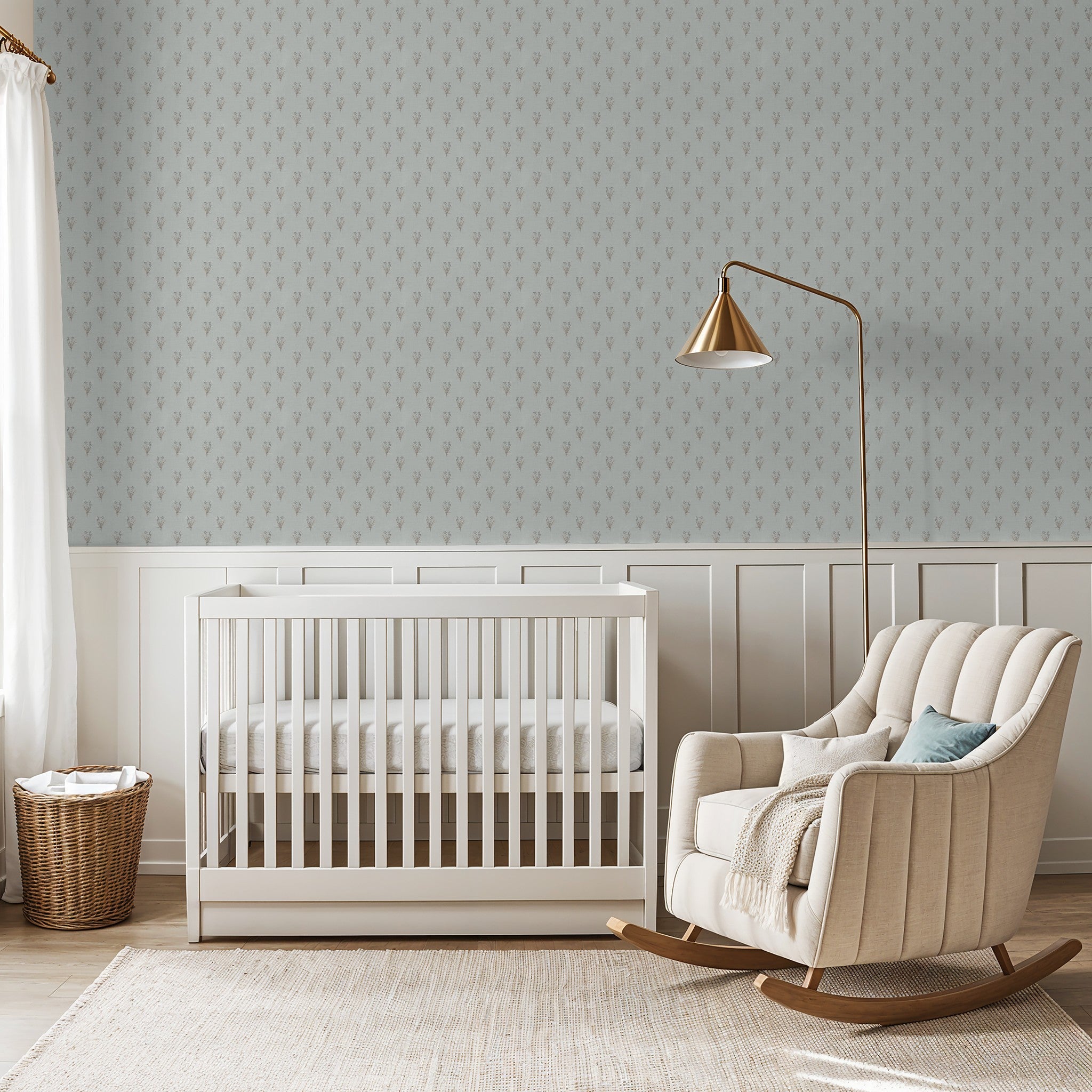 Nursery with delicate botanical wallpaper, white crib, and beige rocking chair.