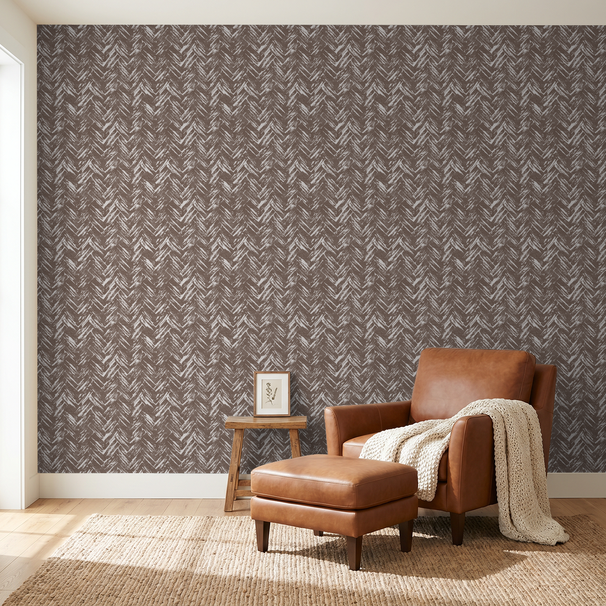 Brown chevron wallpaper with leather chair in cozy living room setting.