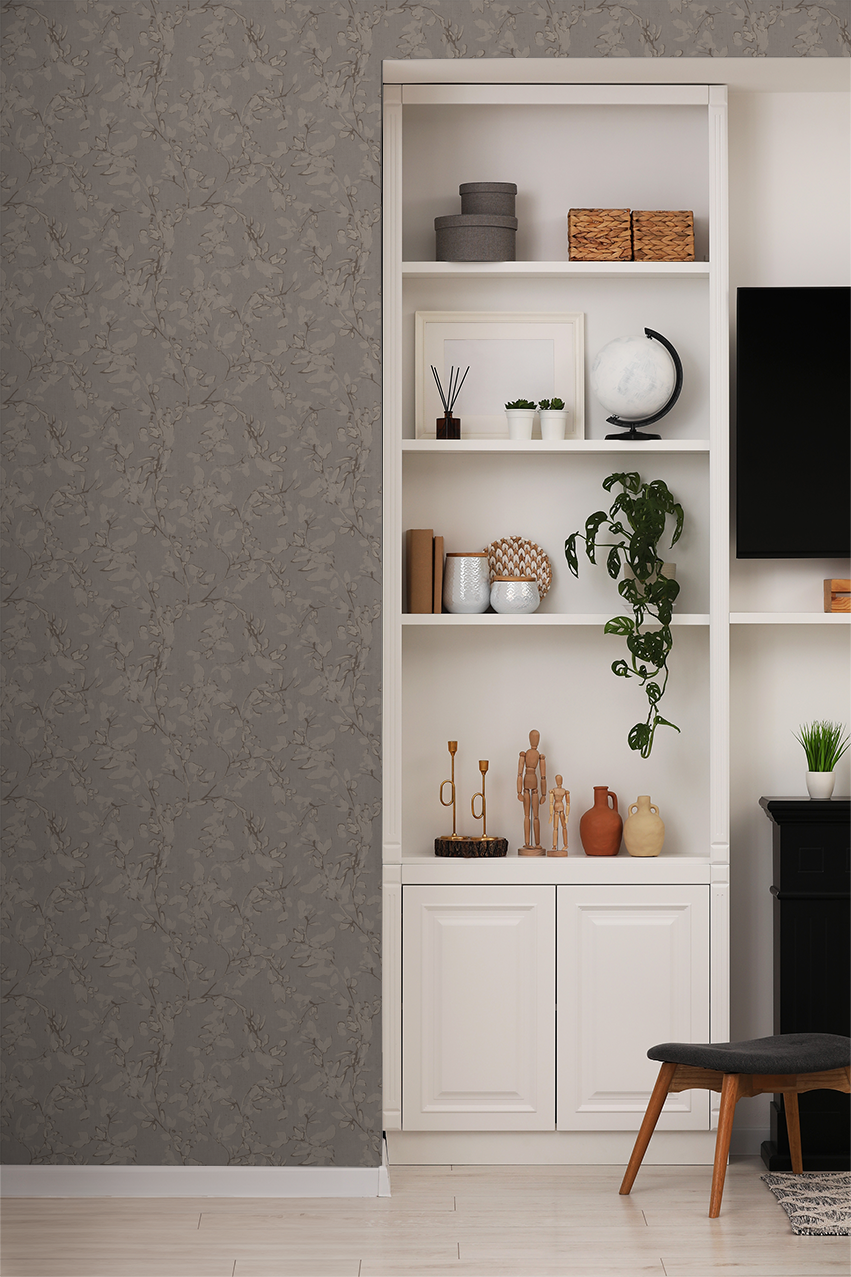 Brown floral vine wallpaper in elegant living room with white shelves and decor.