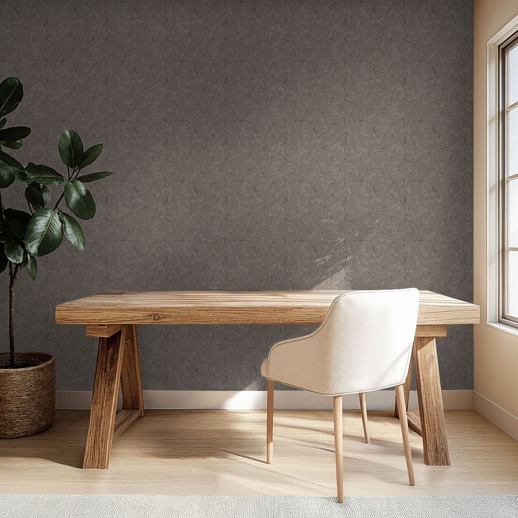 Brown floral vine wallpaper in a minimalist office with wooden desk and chair.