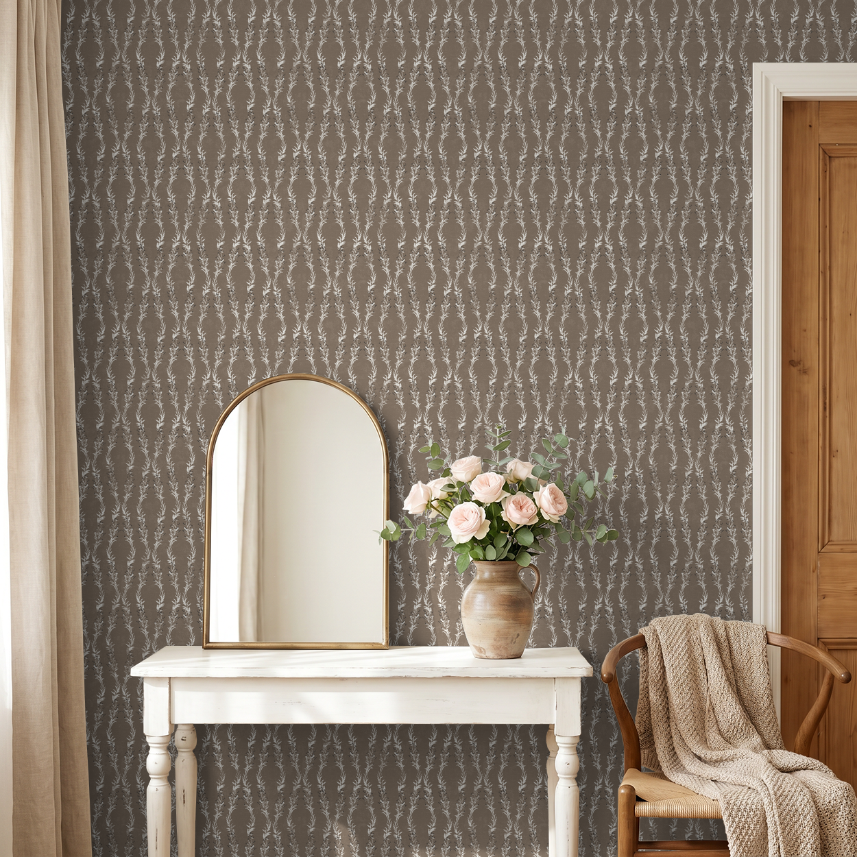 Brown floral vine wallpaper in rustic room with mirror and vase of roses.