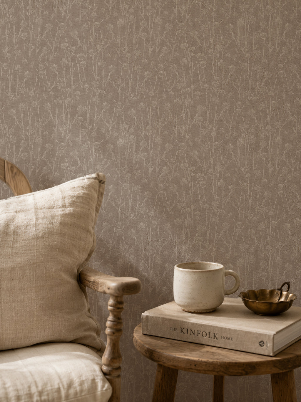 Brown floral wallpaper with delicate wildflower pattern in cozy room setting.