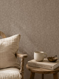 Brown floral wallpaper with delicate wildflower pattern in cozy room setting.