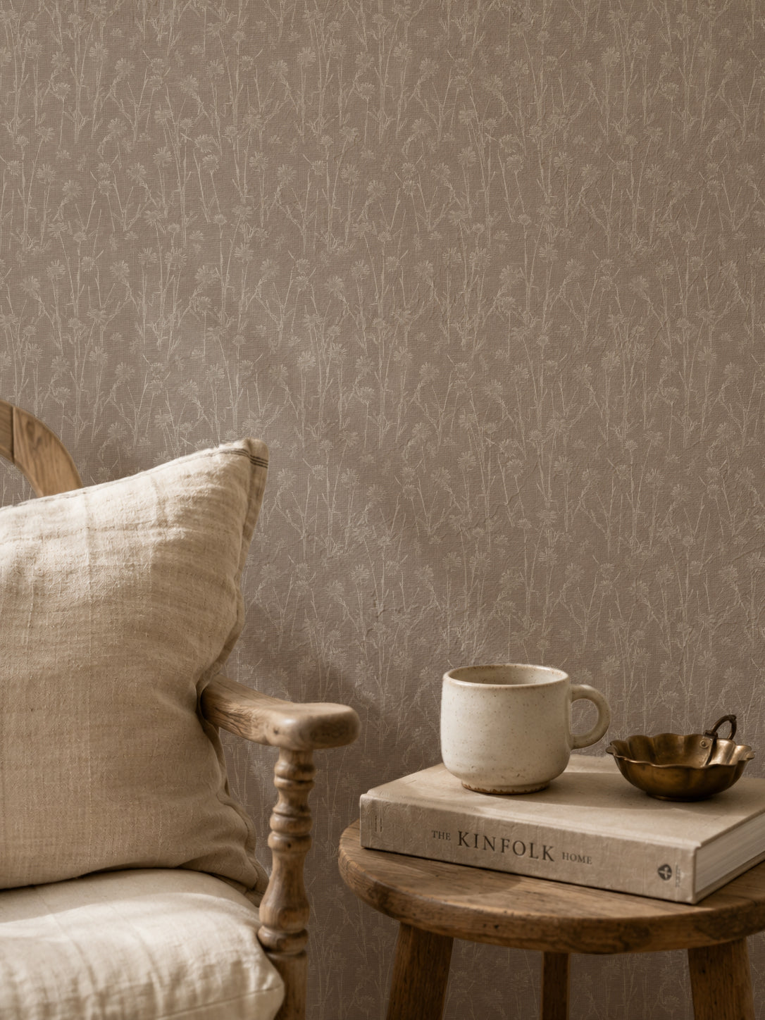 Brown floral wallpaper with delicate wildflower pattern in cozy room setting.