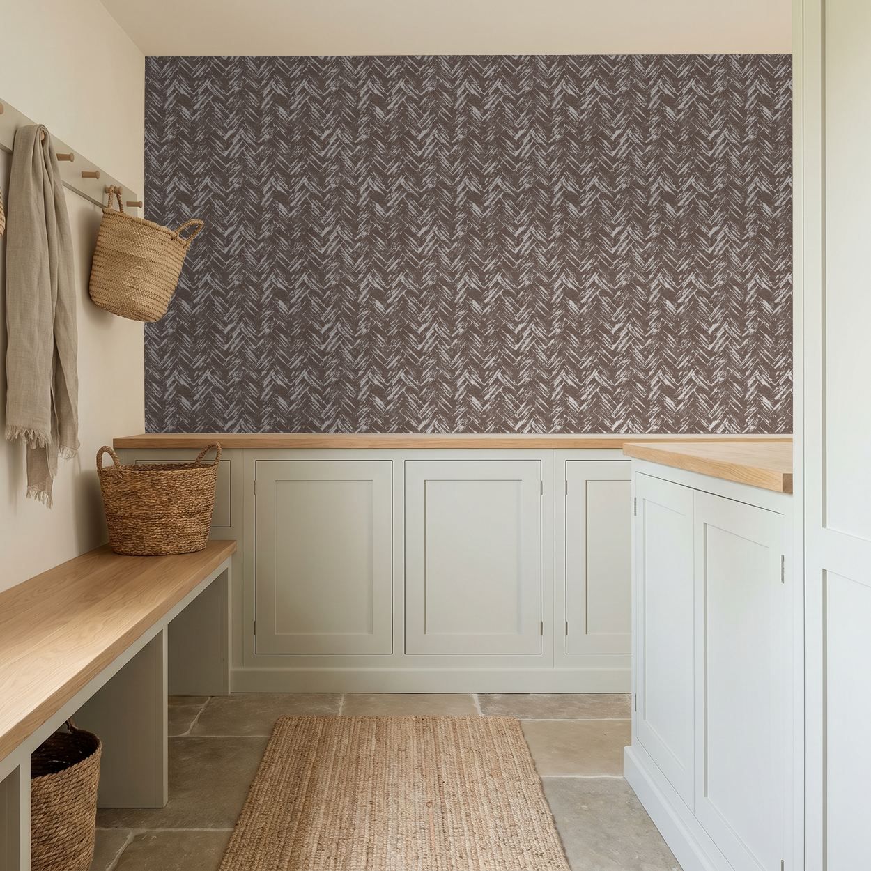 Rustic brown herringbone brushstroke wallpaper in a cozy mudroom with baskets and neutral decor.