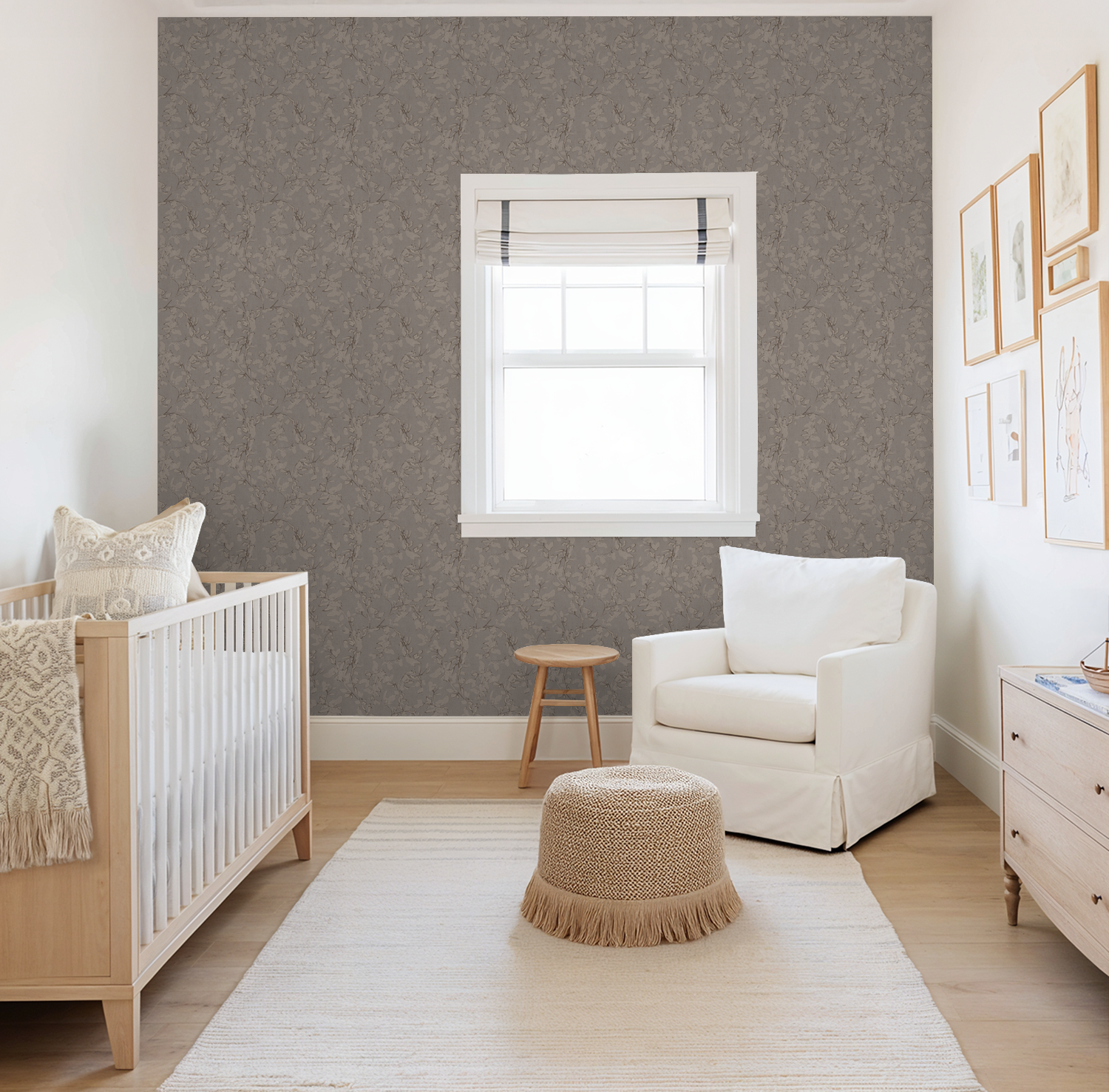 Nursery with brown trailing floral vine wallpaper, white armchair, and wooden crib.
