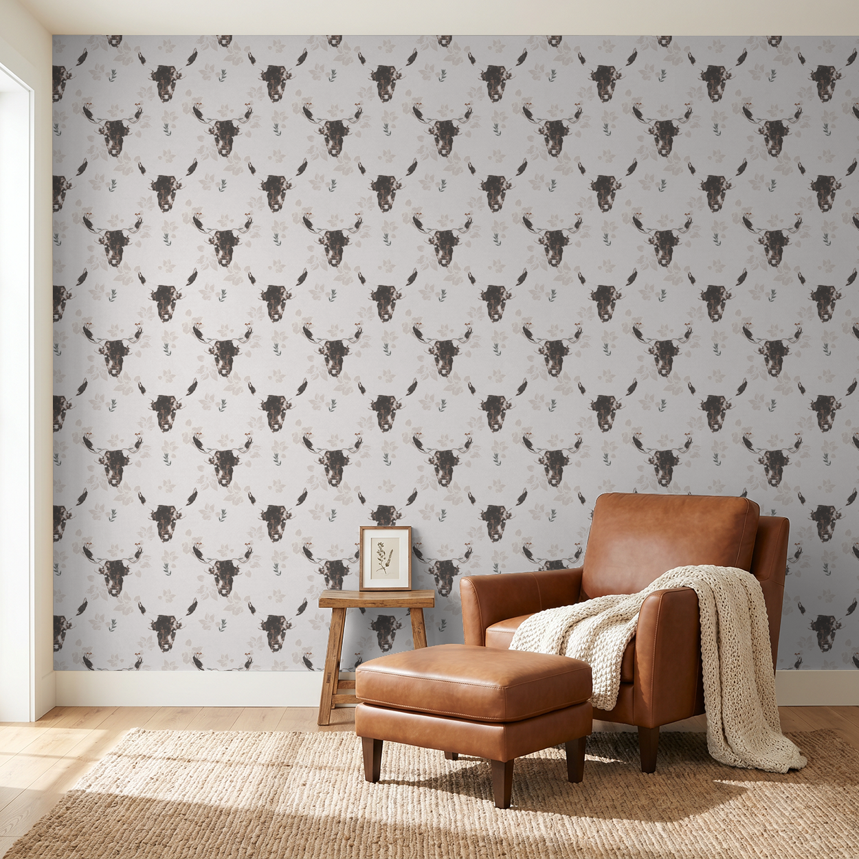 Rustic bull motif wallpaper in earthy tones with leather chair in cozy living room.