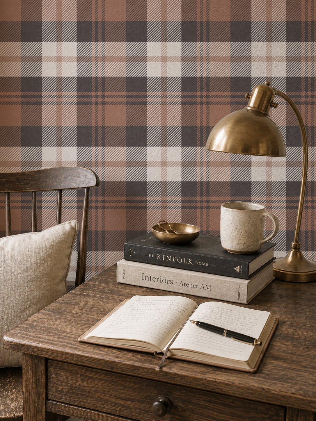 Burnt orange plaid wallpaper in cozy study with wooden desk and lamp.