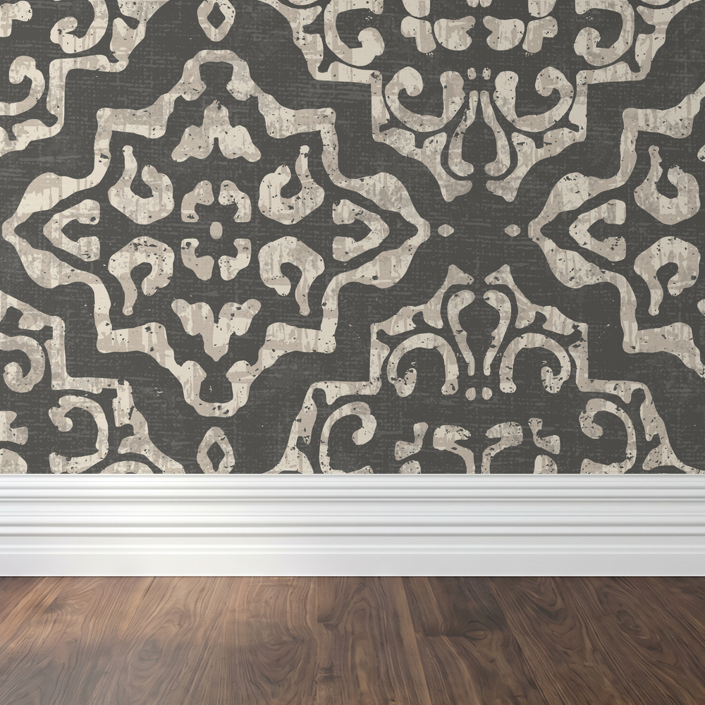 Charcoal and cream damask wallpaper with ornate motifs in a modern room.