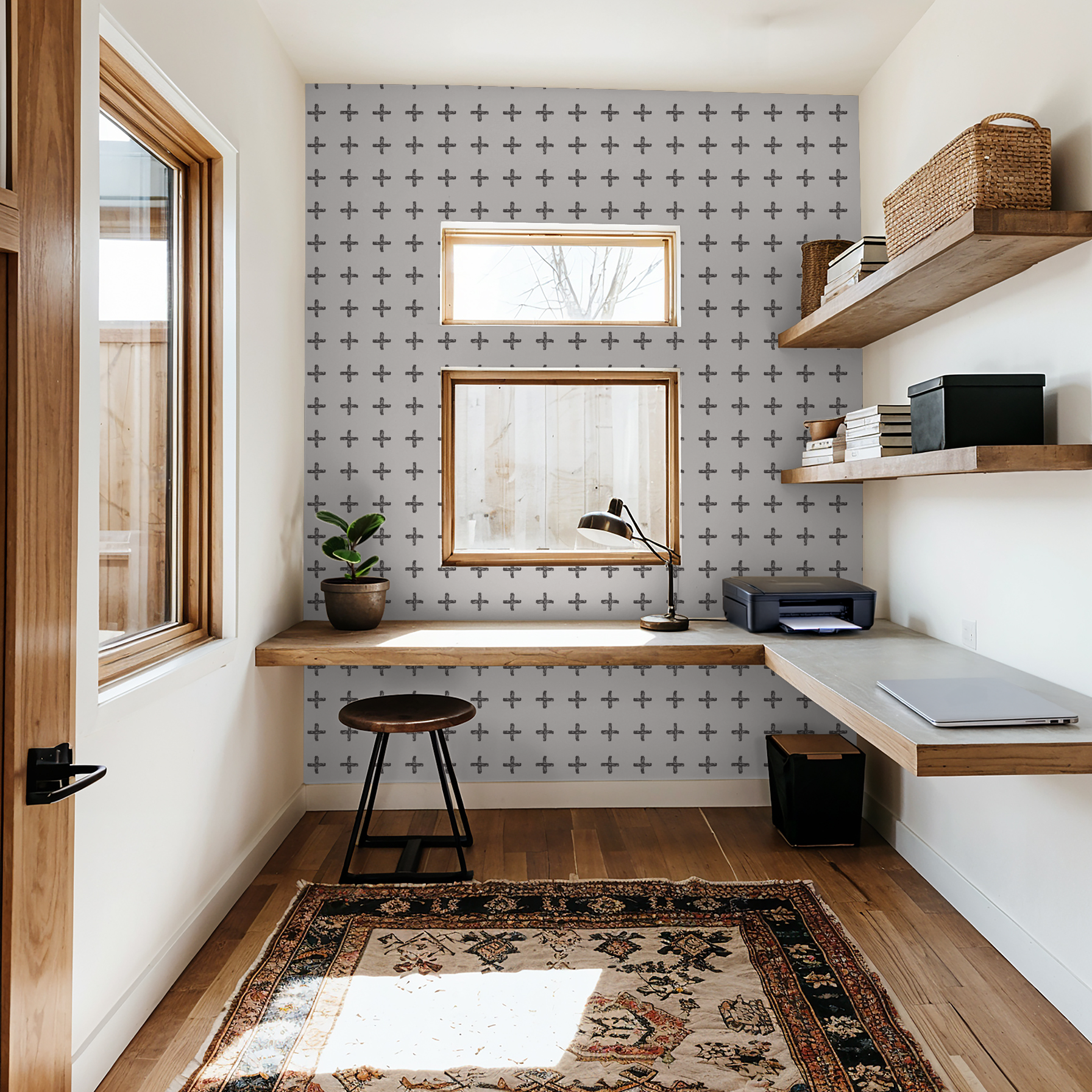 Charcoal cross pattern wallpaper in modern home office with wooden shelves and desk.