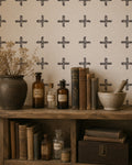 Charcoal painterly cross wallpaper in rustic room with books and vintage decor.