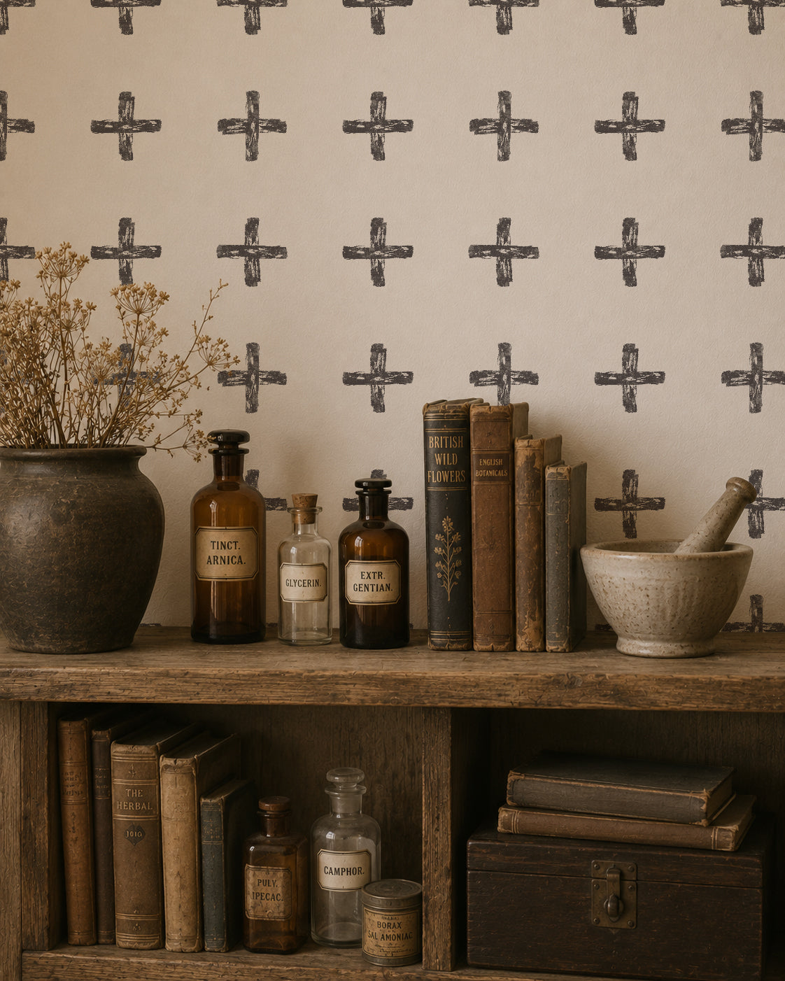 Charcoal painterly cross wallpaper in rustic room with books and vintage decor.