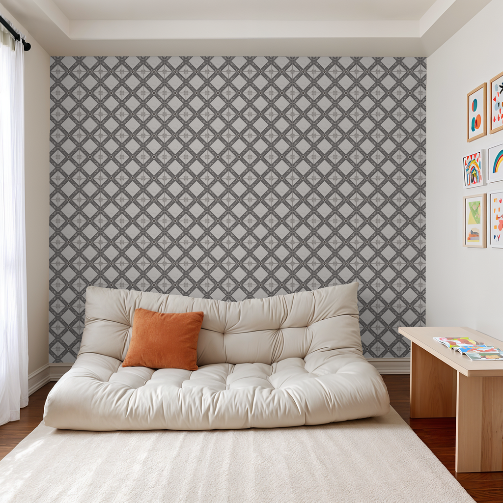 Charcoal gray botanical trellis wallpaper in modern living room with beige sofa and orange pillow.