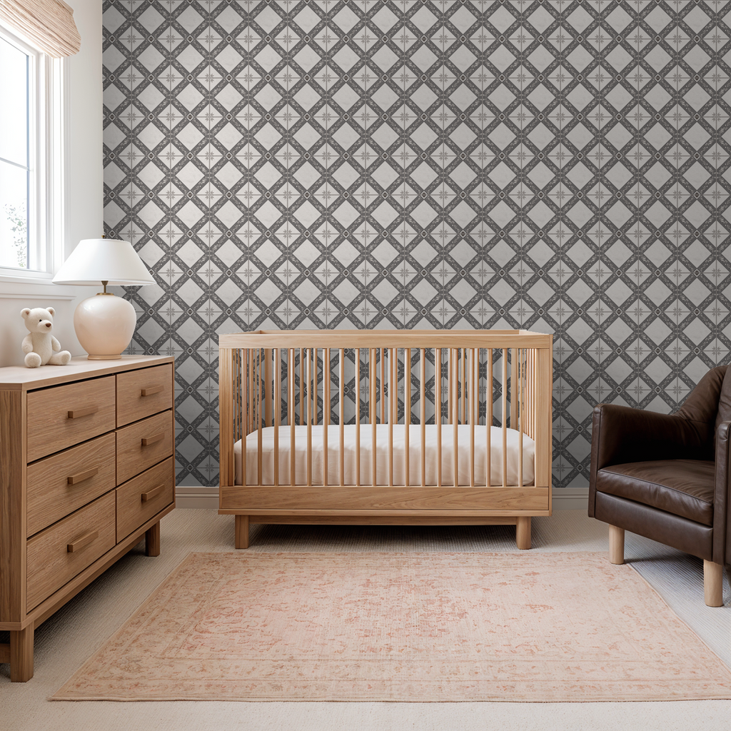 Charcoal gray botanical trellis wallpaper in nursery with wooden crib and dresser.