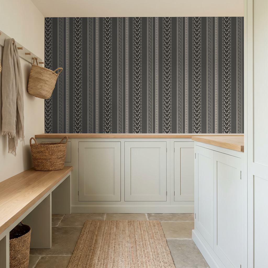 Charcoal ornamental stripe wallpaper in modern mudroom with baskets and bench.