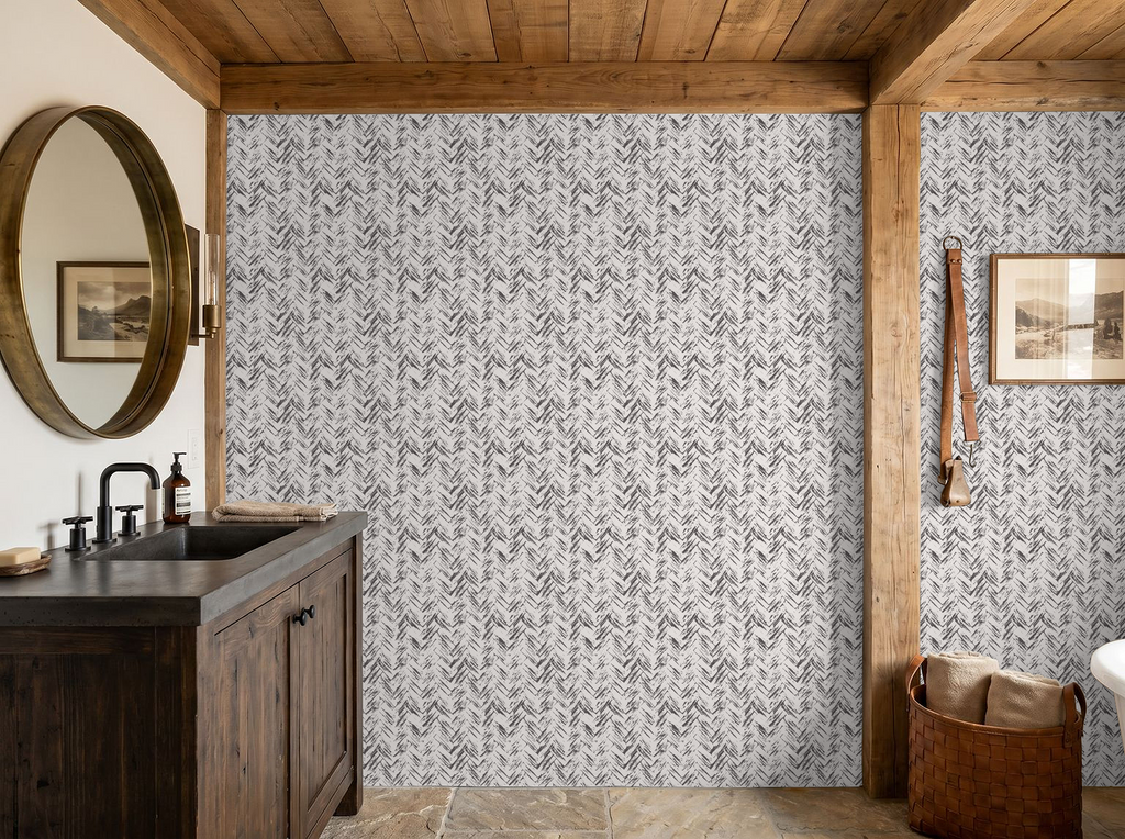 Rustic bathroom with cream and charcoal herringbone wallpaper, wooden vanity and mirror.