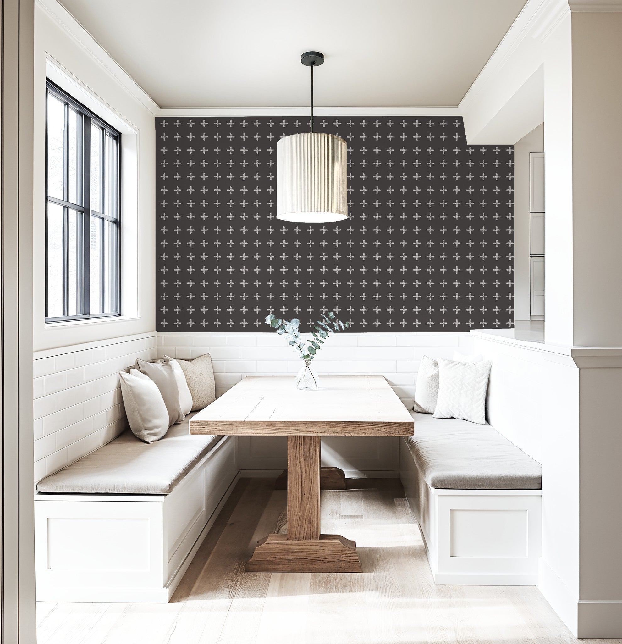 Modern dining nook with cream cross pattern wallpaper on charcoal wall.