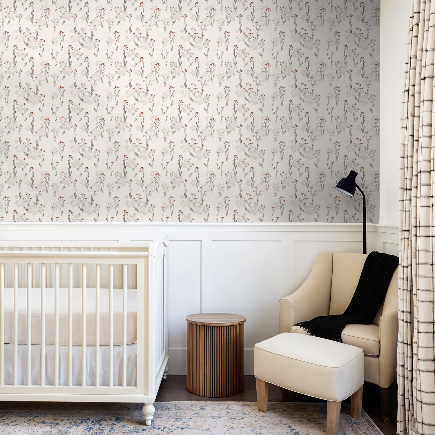 Nursery with cream floral wallpaper featuring delicate wildflower pattern.