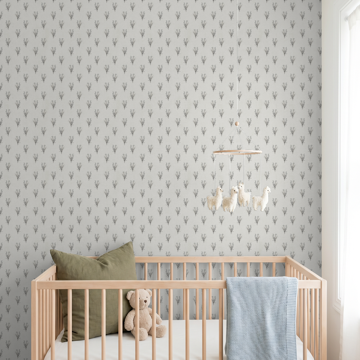 Cream wildflower bouquet wallpaper in a nursery with wooden crib and plush toys.