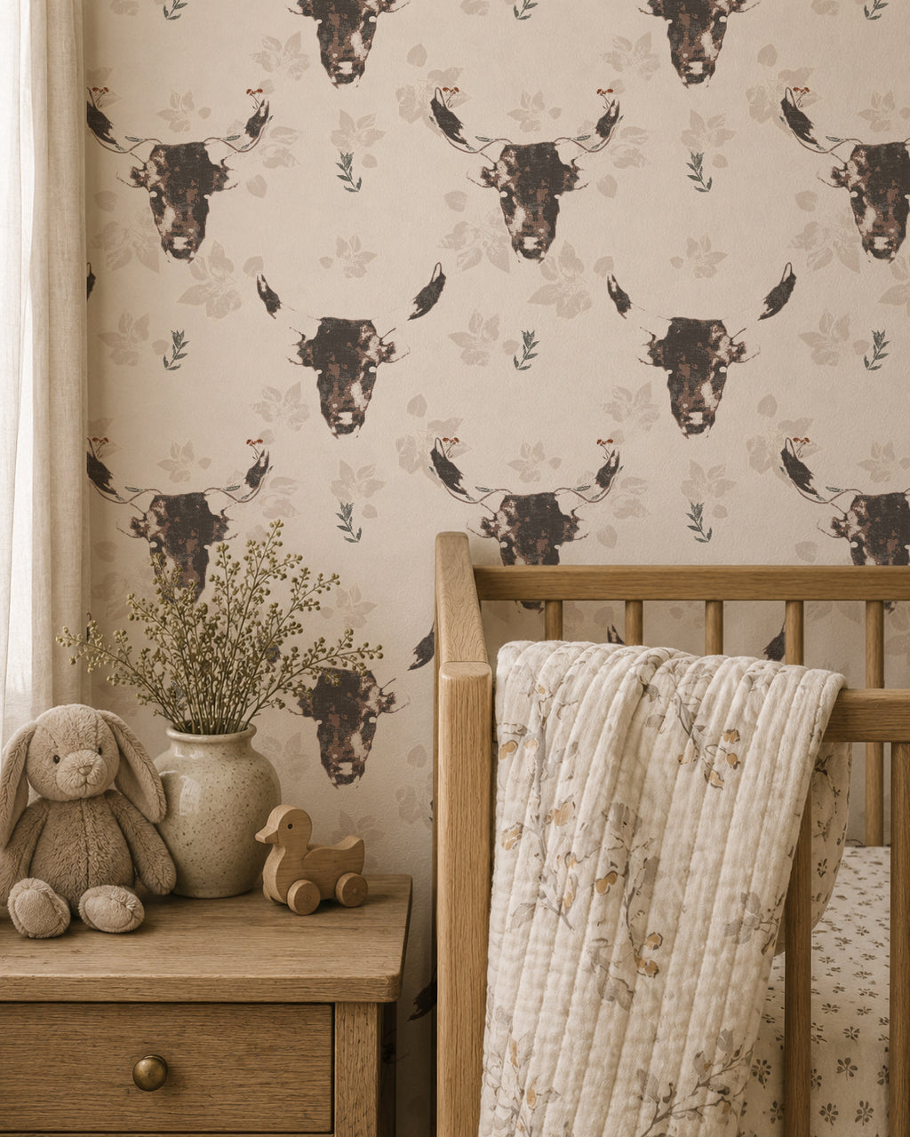 Rustic nursery with Dakota Prairie Longhorn wallpaper featuring bull motifs in brown and cream.