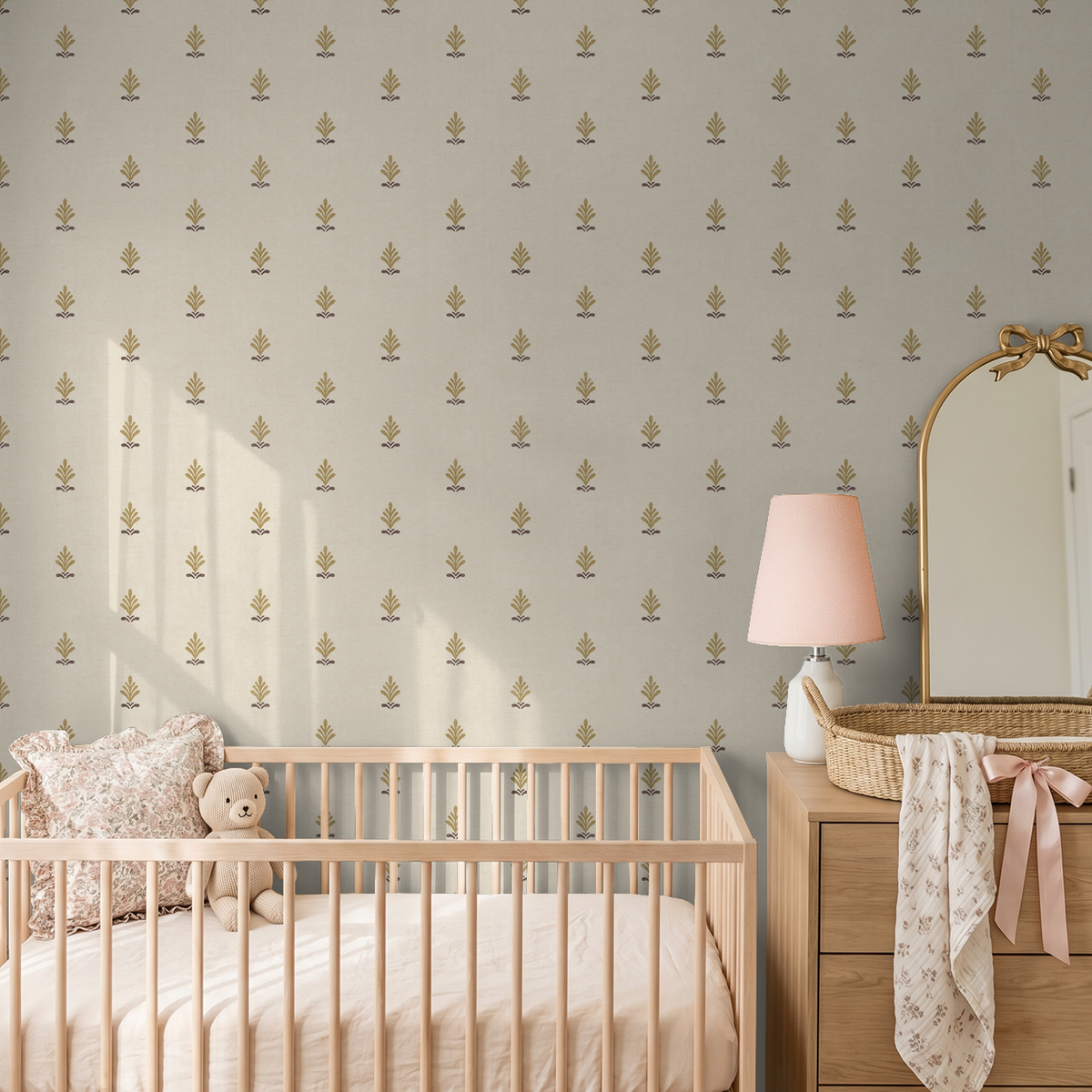 Elegant gold motif wallpaper in nursery with crib and dresser.
