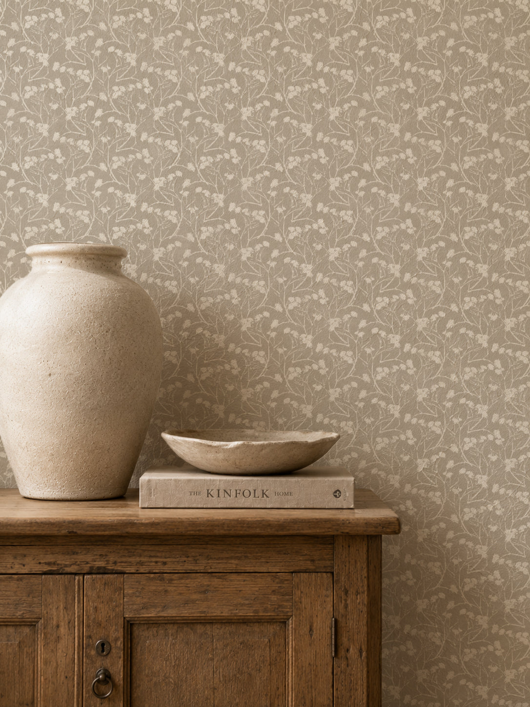Floral stone wallpaper with delicate white blooms in rustic room setting.
