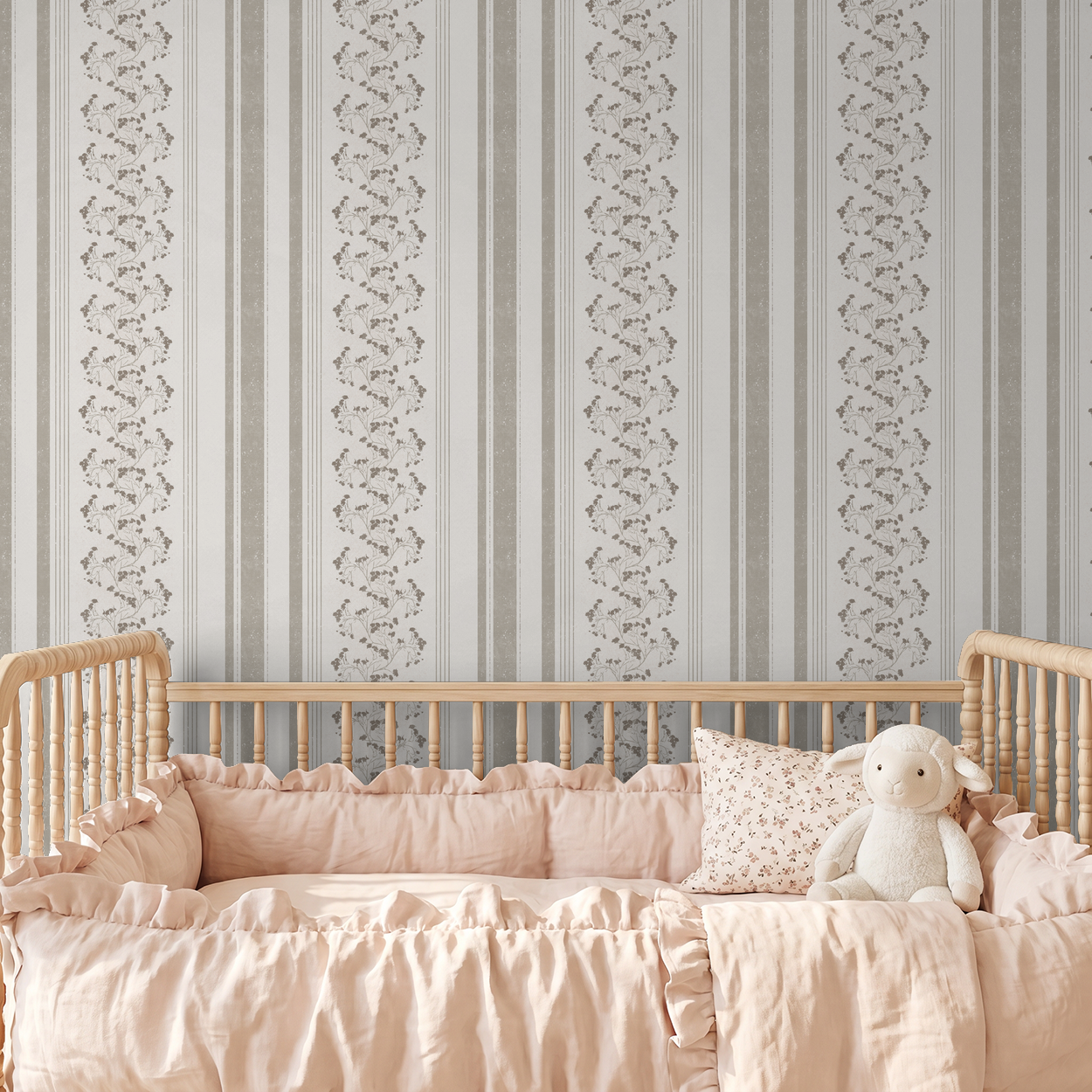 Floral stripe taupe cream wallpaper in nursery with wooden crib and pink bedding.