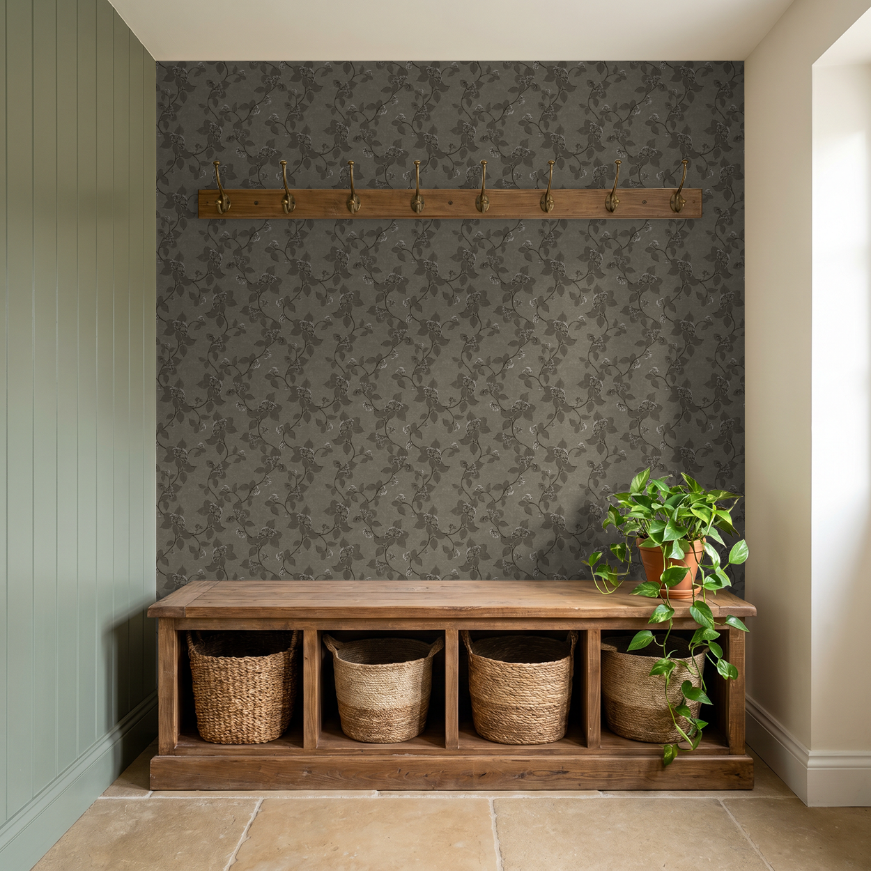Floral vine wallpaper in earth tones in a rustic entryway with wooden bench and plant.