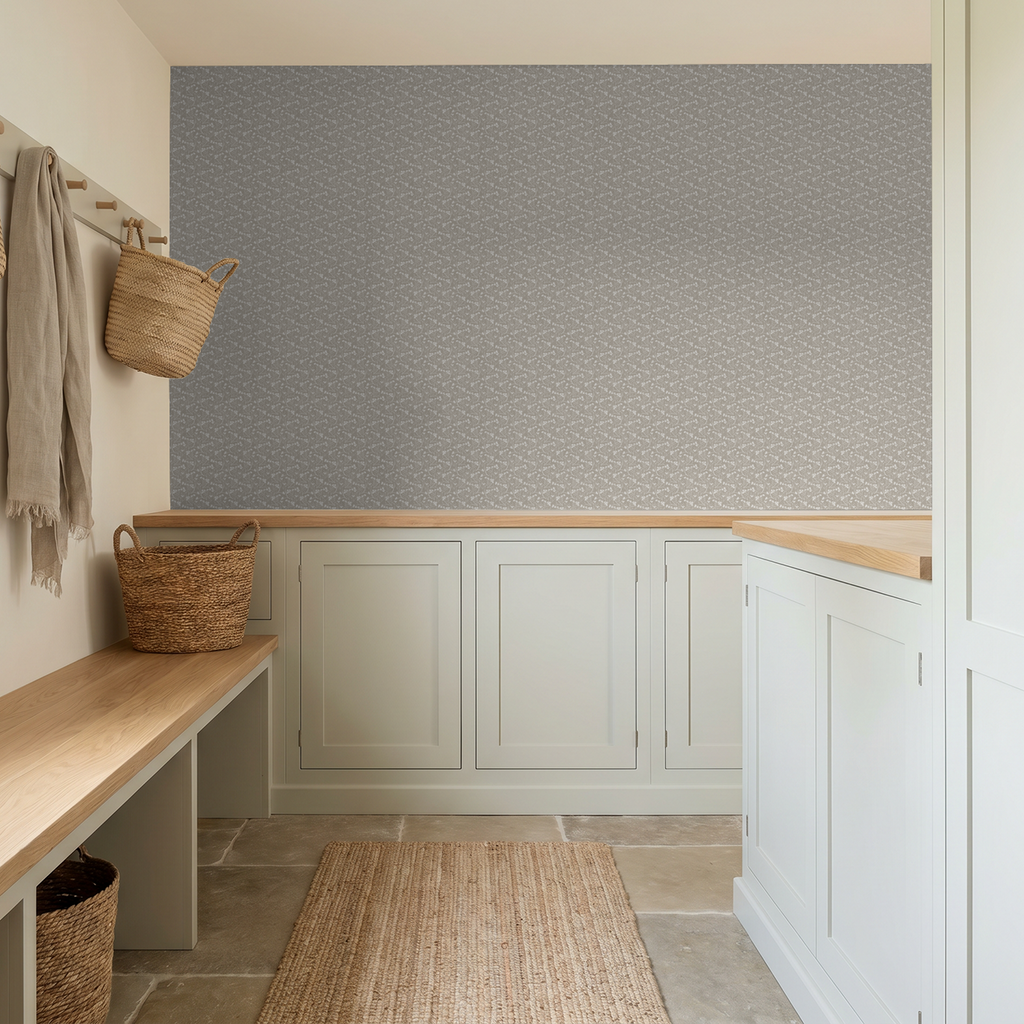 Floral wallpaper with stone backdrop in rustic mudroom with woven baskets.
