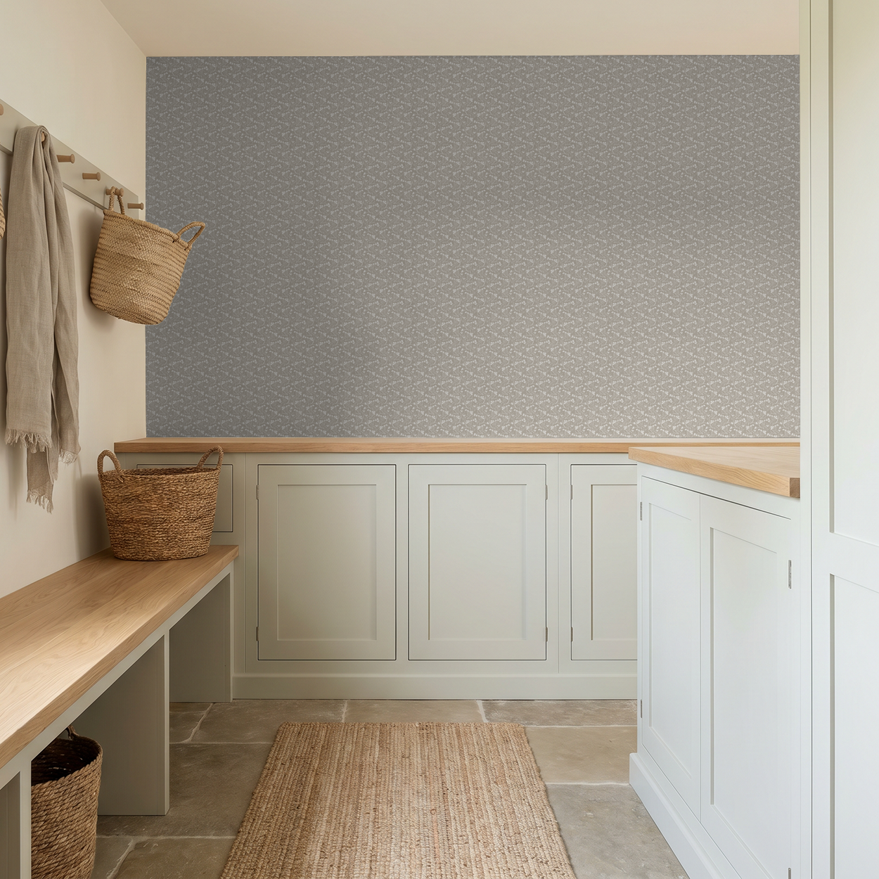 Floral wallpaper with stone backdrop in rustic mudroom with woven baskets.