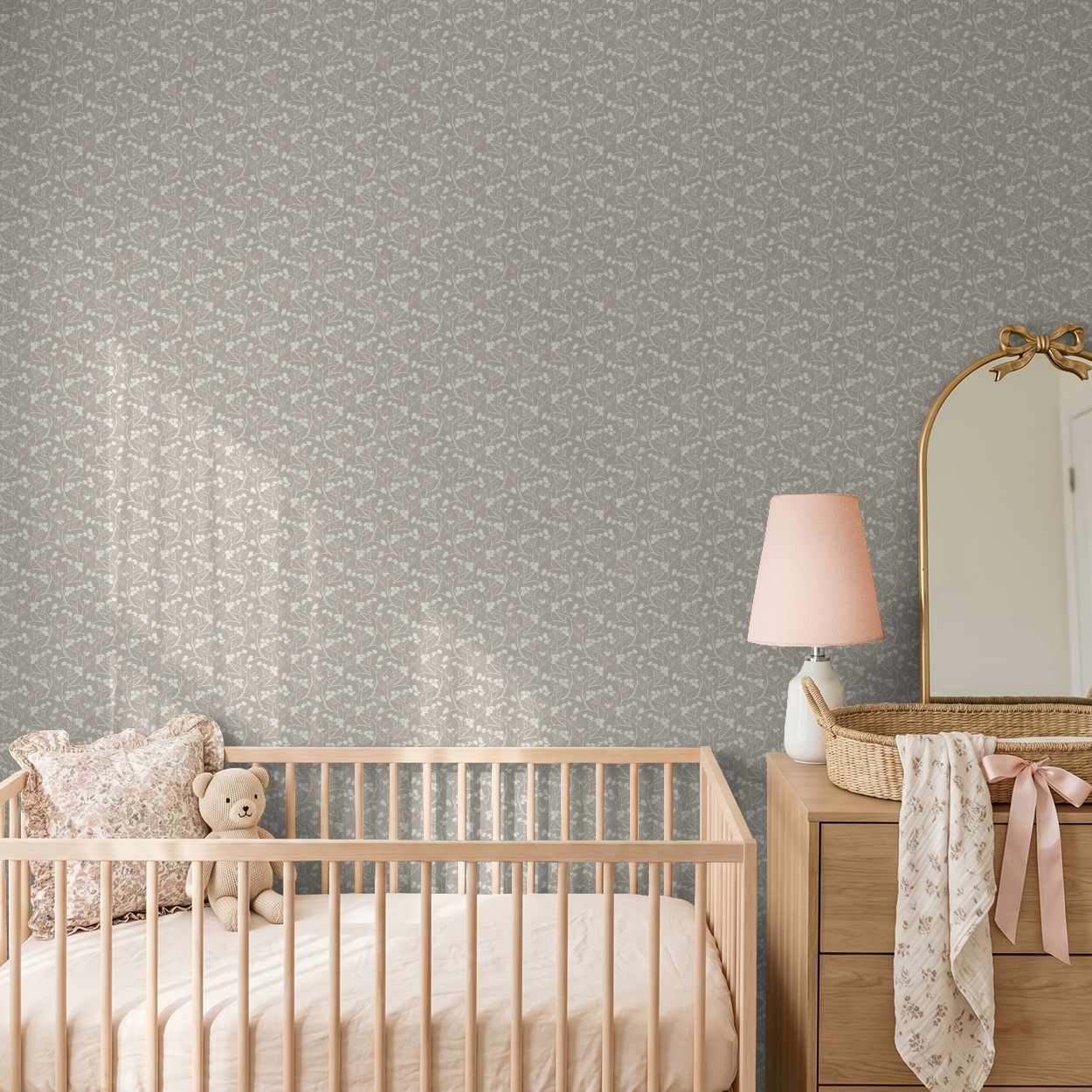 Floral wallpaper with stone backdrop in a nursery with crib and dresser.