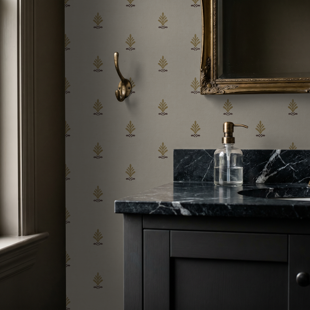 Elegant gold motif wallpaper in bathroom with dark marble sink