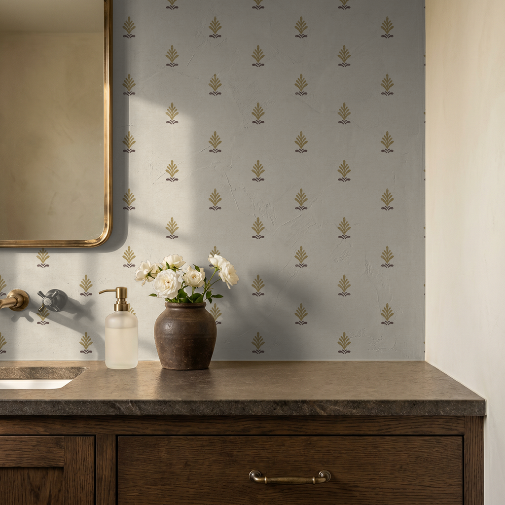 Elegant gold and taupe motif wallpaper in a rustic bathroom setting with wooden vanity.