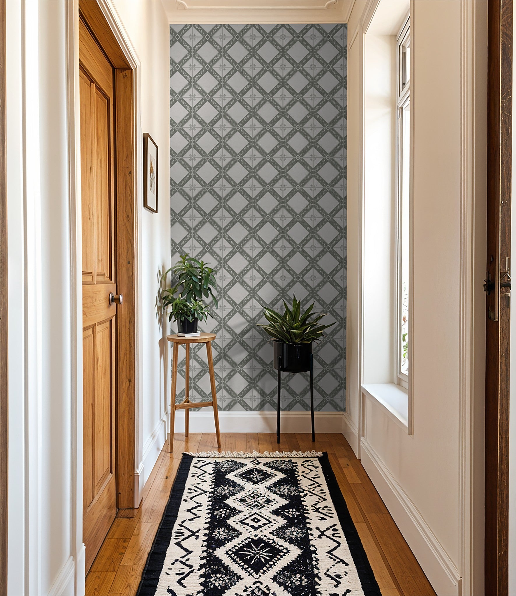 Gray geometric wallpaper in hallway with plants and patterned rug