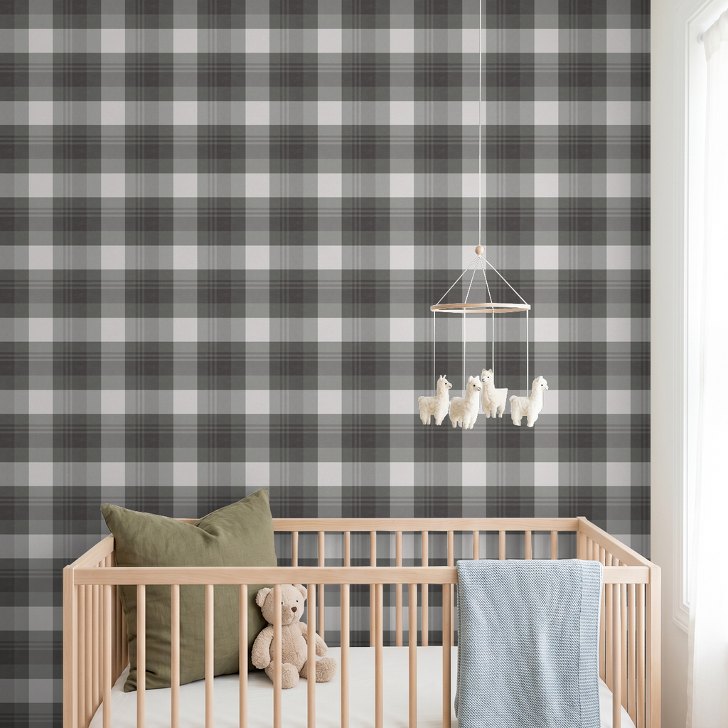 Green and charcoal plaid wallpaper in a nursery with crib and teddy bear.