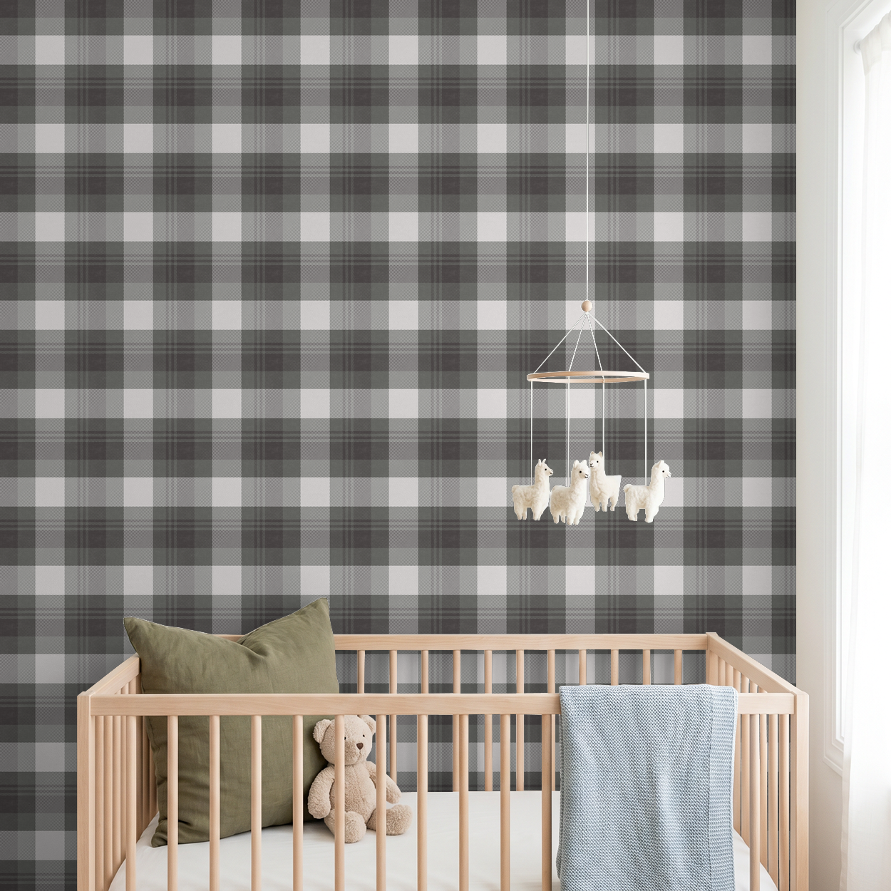 Green and charcoal plaid wallpaper in a nursery with crib and teddy bear.
