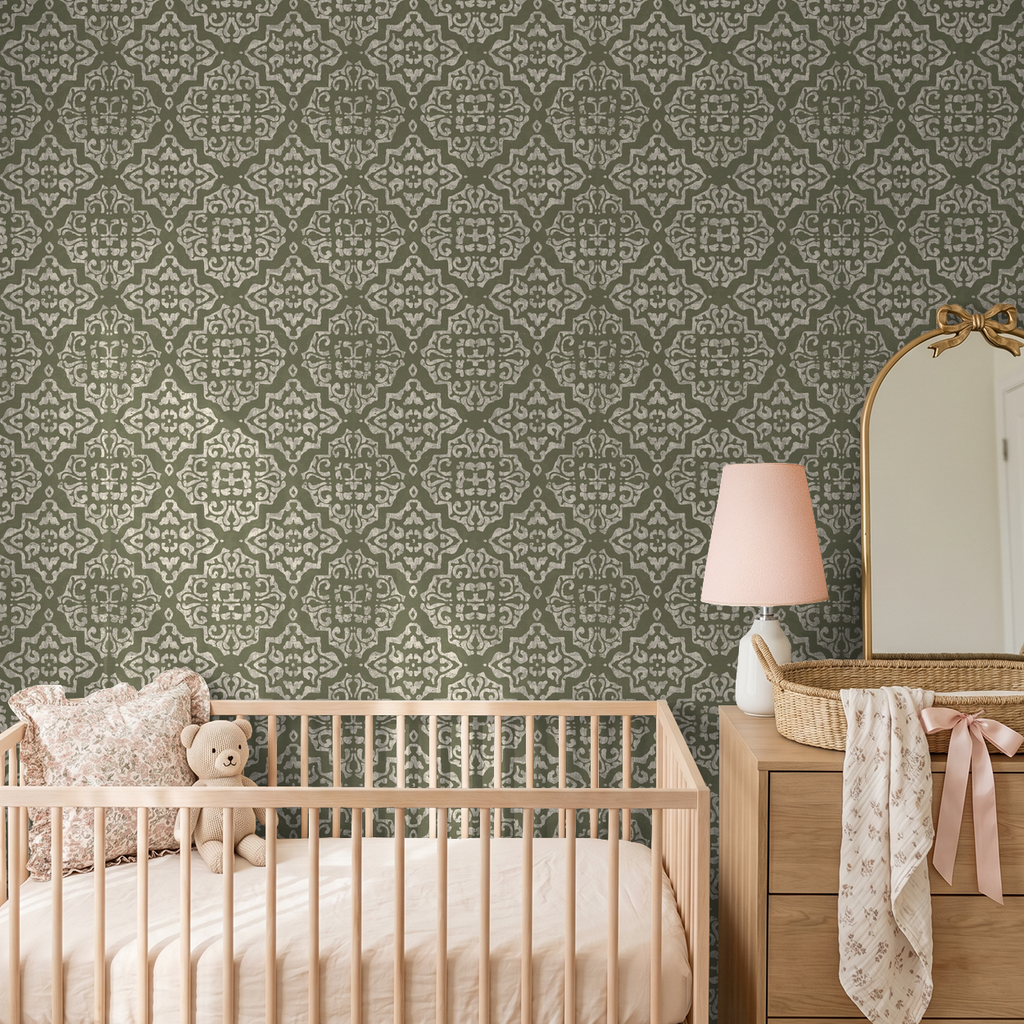 Ornate moss green damask wallpaper in nursery with crib and dresser.