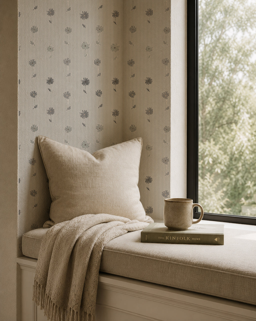 Navy daisy stripe wallpaper in cozy reading nook with beige pillow and throw.